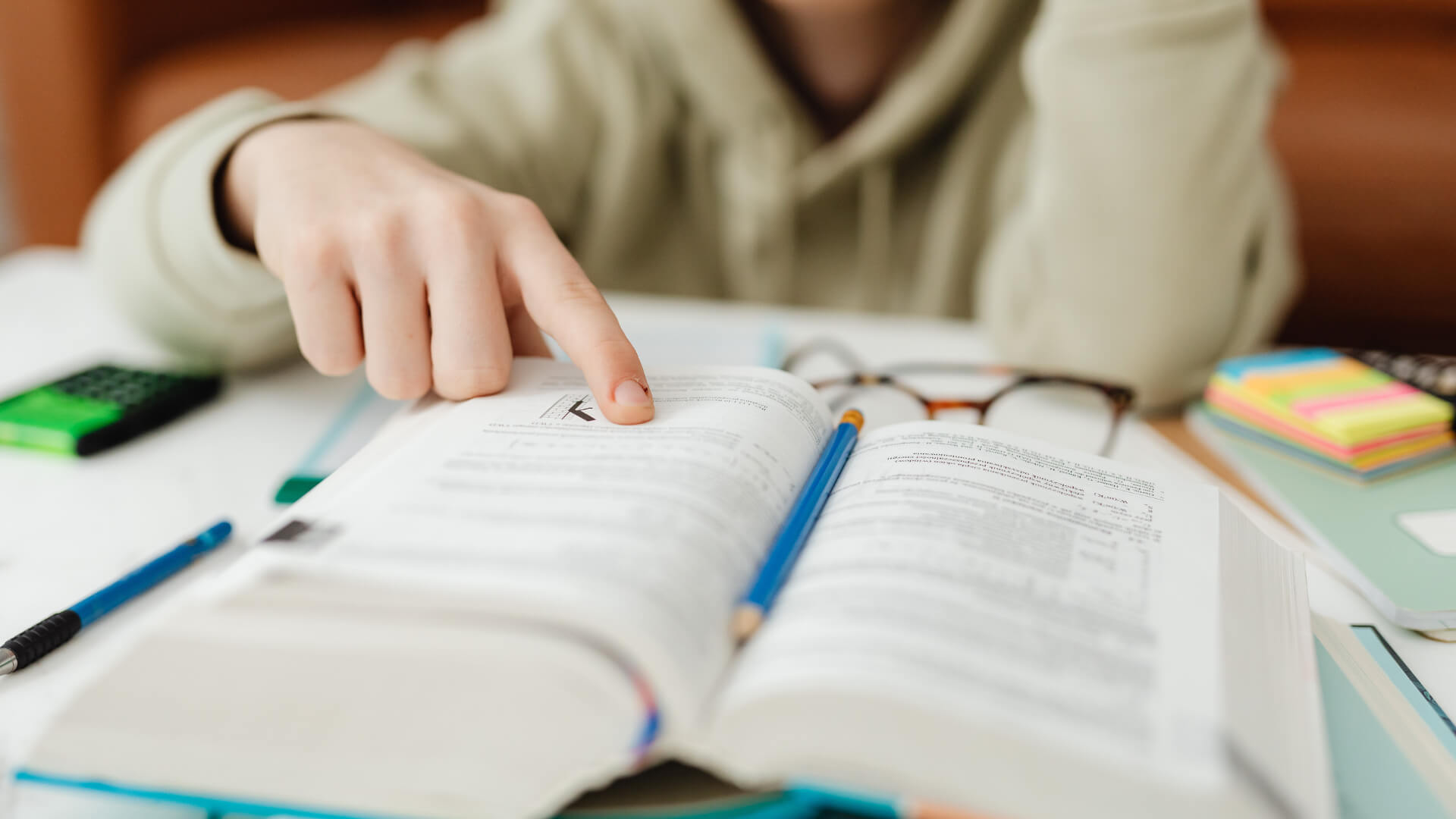A child reading a book, preparing for the 11 plus comprehension assessment